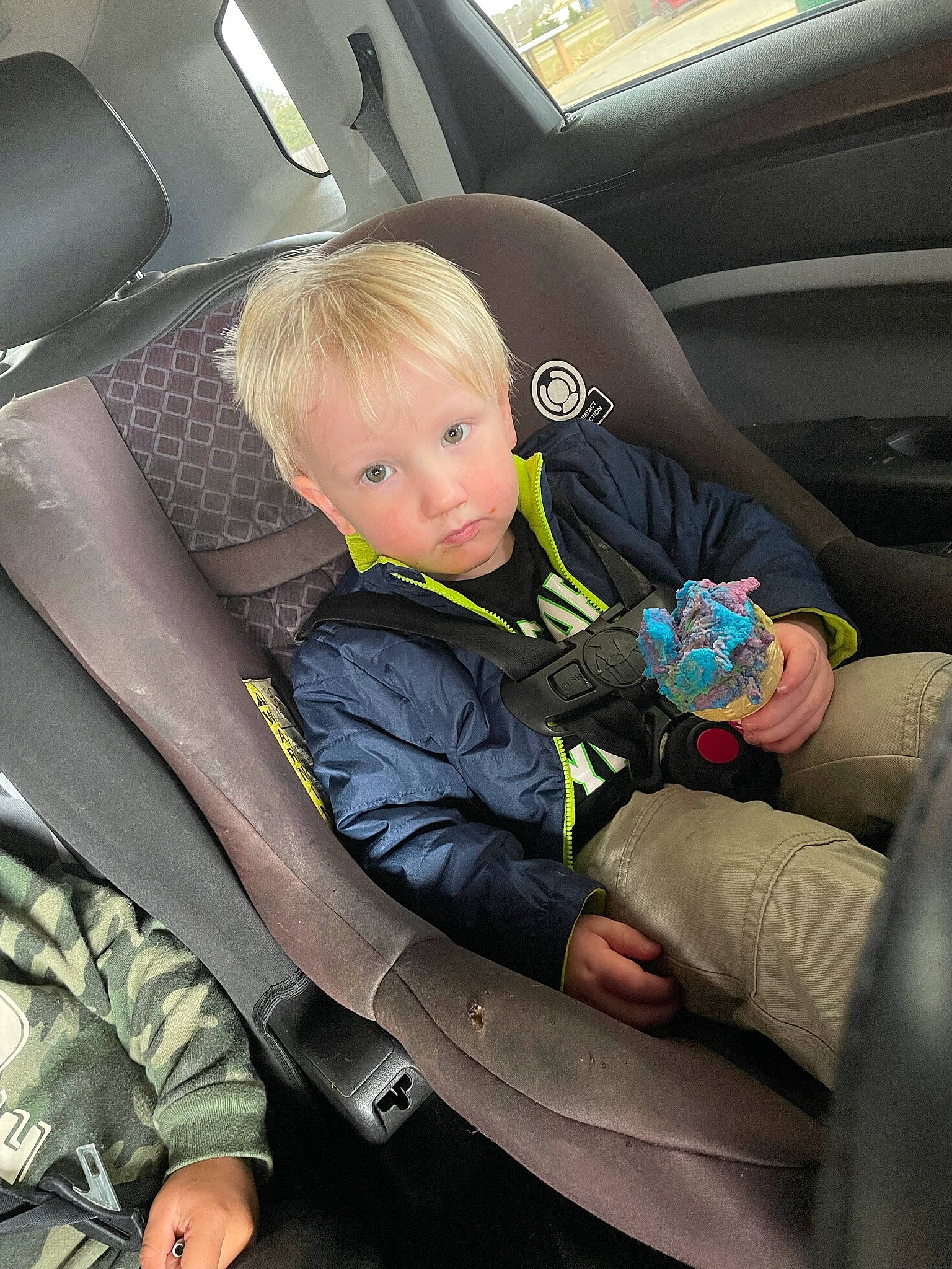 Sam is registered to the contest to win money with this photo: auto_part, automotive_design, automotive_exterior, car, car_seat, car_seat_cover, child, comfort, head_restraint, leg, mode_of_transport, motor_vehicle, person, personal_luxury_car, plant, product, steering_part, steering_wheel, toddler, vehicle