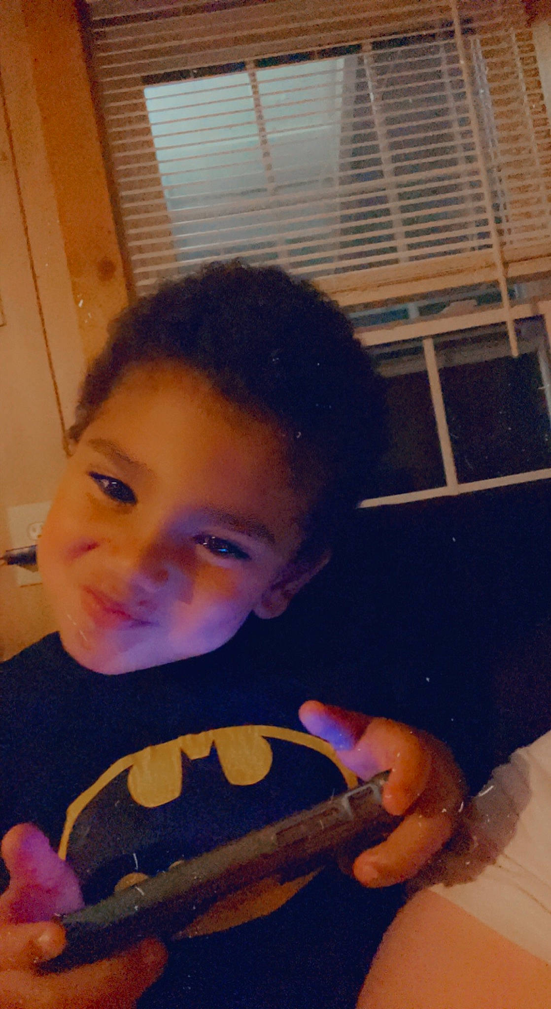 Bradley is registered to the contest to win money with this photo: baby_toddler_clothing, child, comfort_food, cool, finger, flooring, fun, happy, jaw, joy, mouth, musical_instrument, nail, nose, person, play, sitting, skin, smile, t_shirt