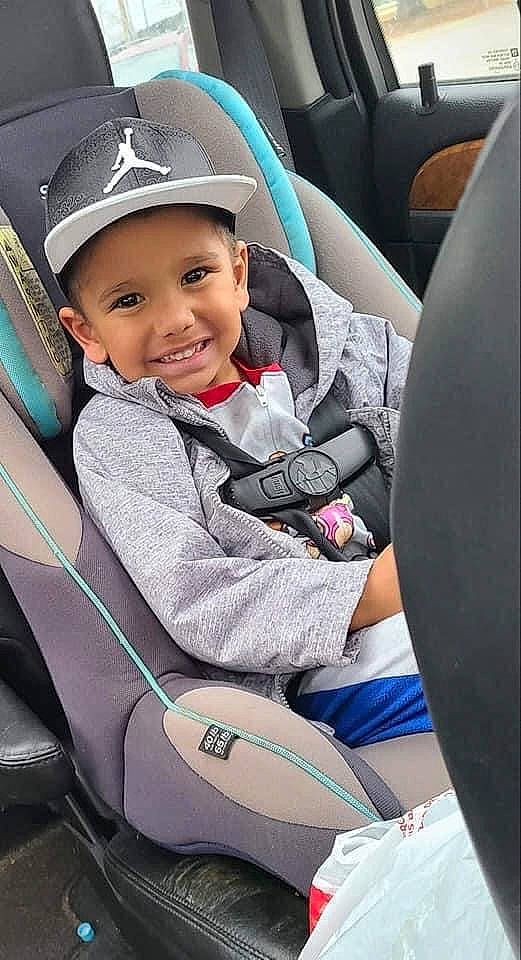 Bradley is registered to the contest to win money with this photo: automotive_design, baby_carriage, baby_in_car_seat, baseball_cap, cap, car, car_seat, car_seat_cover, comfort, cool, head_restraint, headwear, joy, motor_vehicle, person, product, smile, steering_part, steering_wheel, toddler