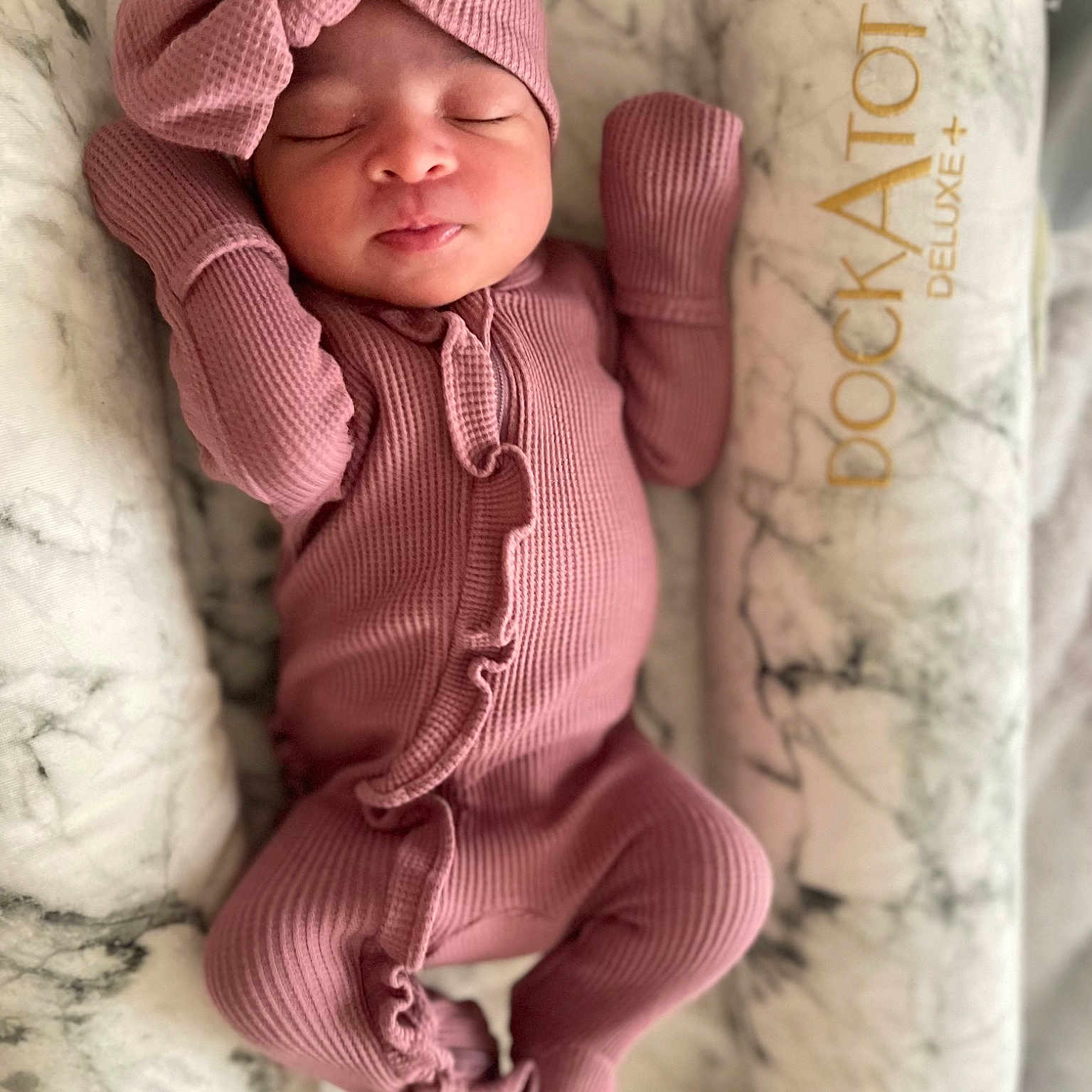 Aaleiyah is registered to the contest to win money with this photo: baby, baby_sleeping, baby_toddler_clothing, cap, cheek, comfort, eye, face, headgear, linens, lip, outerwear, pattern, pink, skin, sleeve, textile, toddler, toy, wood