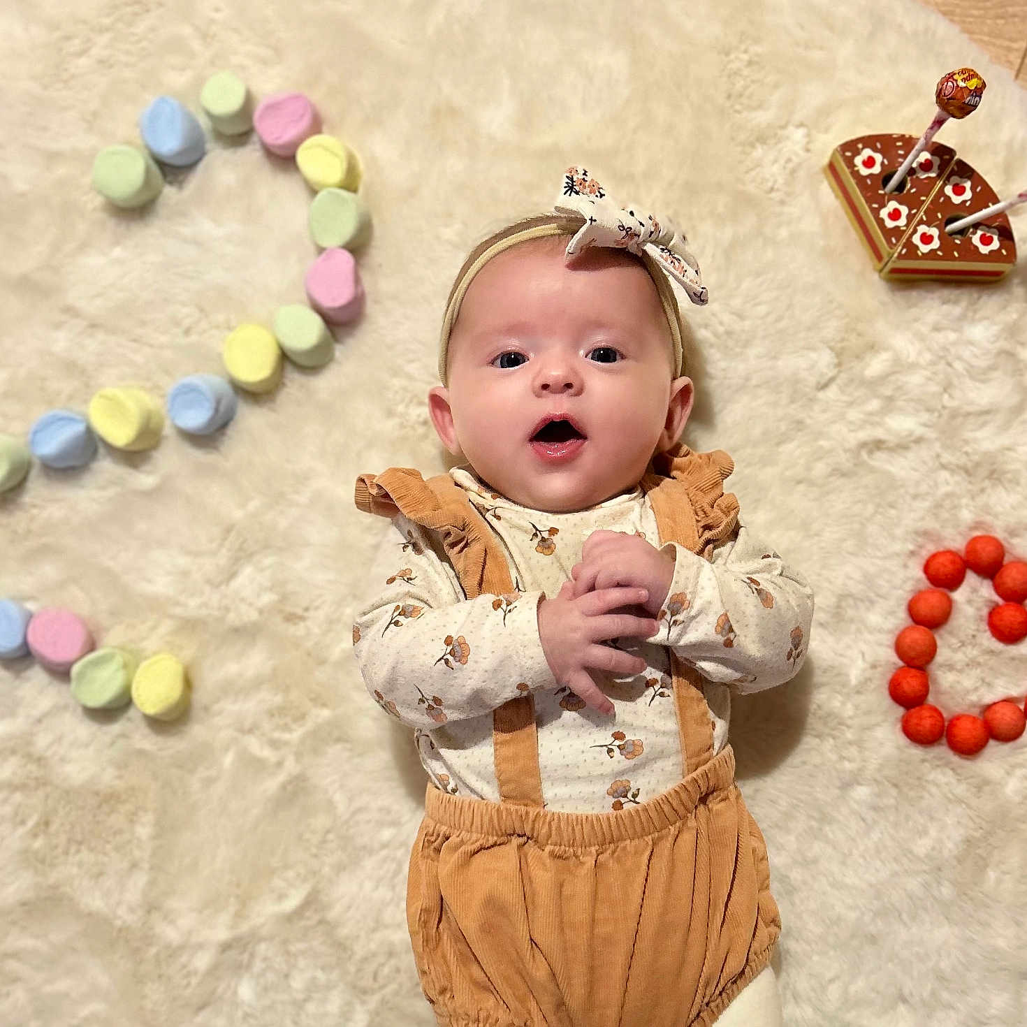 Amaya participe au concours pour gagner de l'argent avec cette photo : baby, cake_toy, celebration, child, clothing, cute, headband, heart_shape, indoors, infant, lollipops, lying_down, marshmallows, number_two, orange_balls, playful, portrait, soft_rug, suspenders, wooden_floor