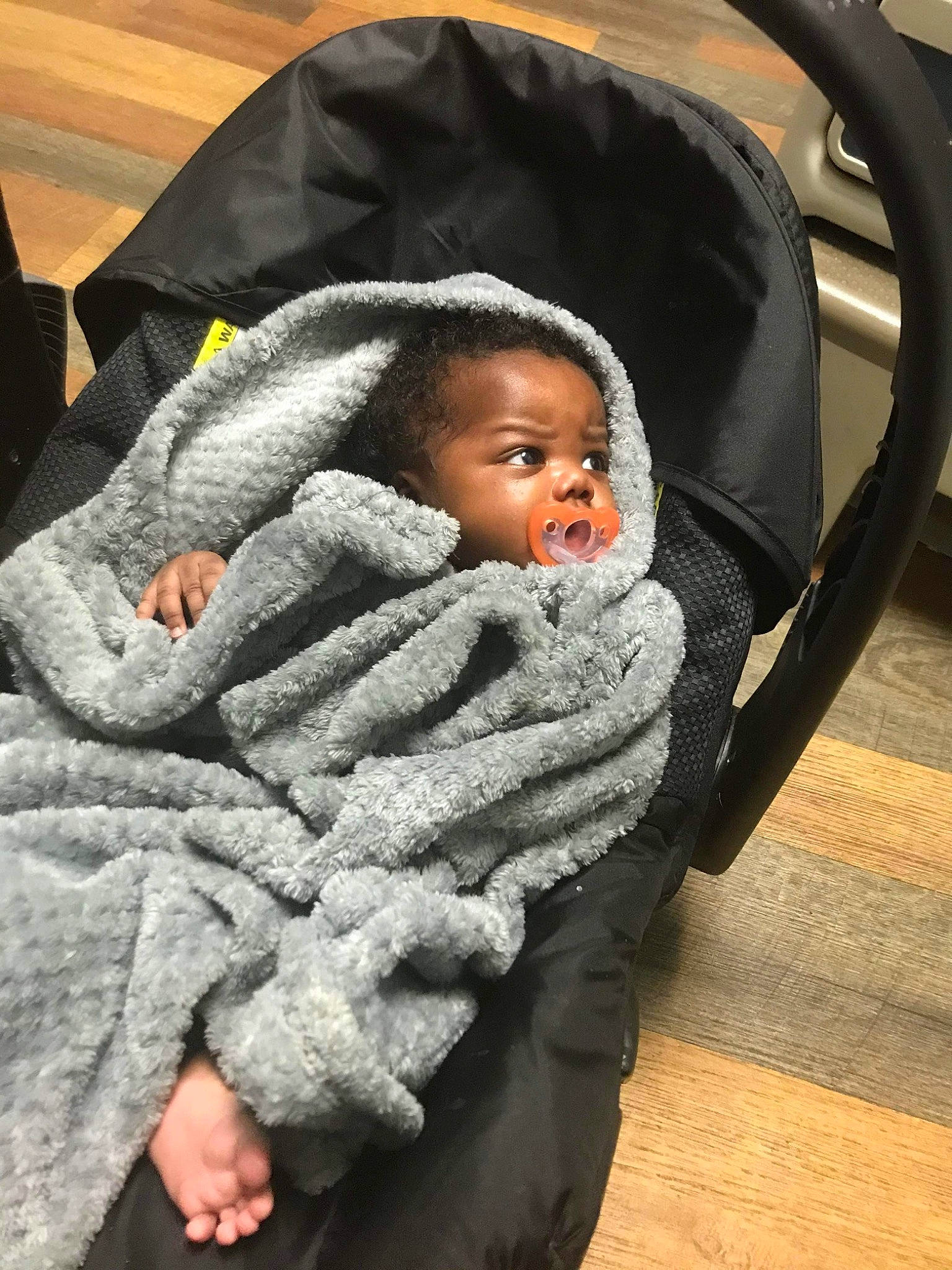 Dameir is registered to the contest to win money with this photo: baby, baby_products, baby_toddler_clothing, chair, cheek, child, comfort, eye, flooring, fun, fur, hardwood, linens, person, product, room, sitting, toddler, wood, wood_flooring