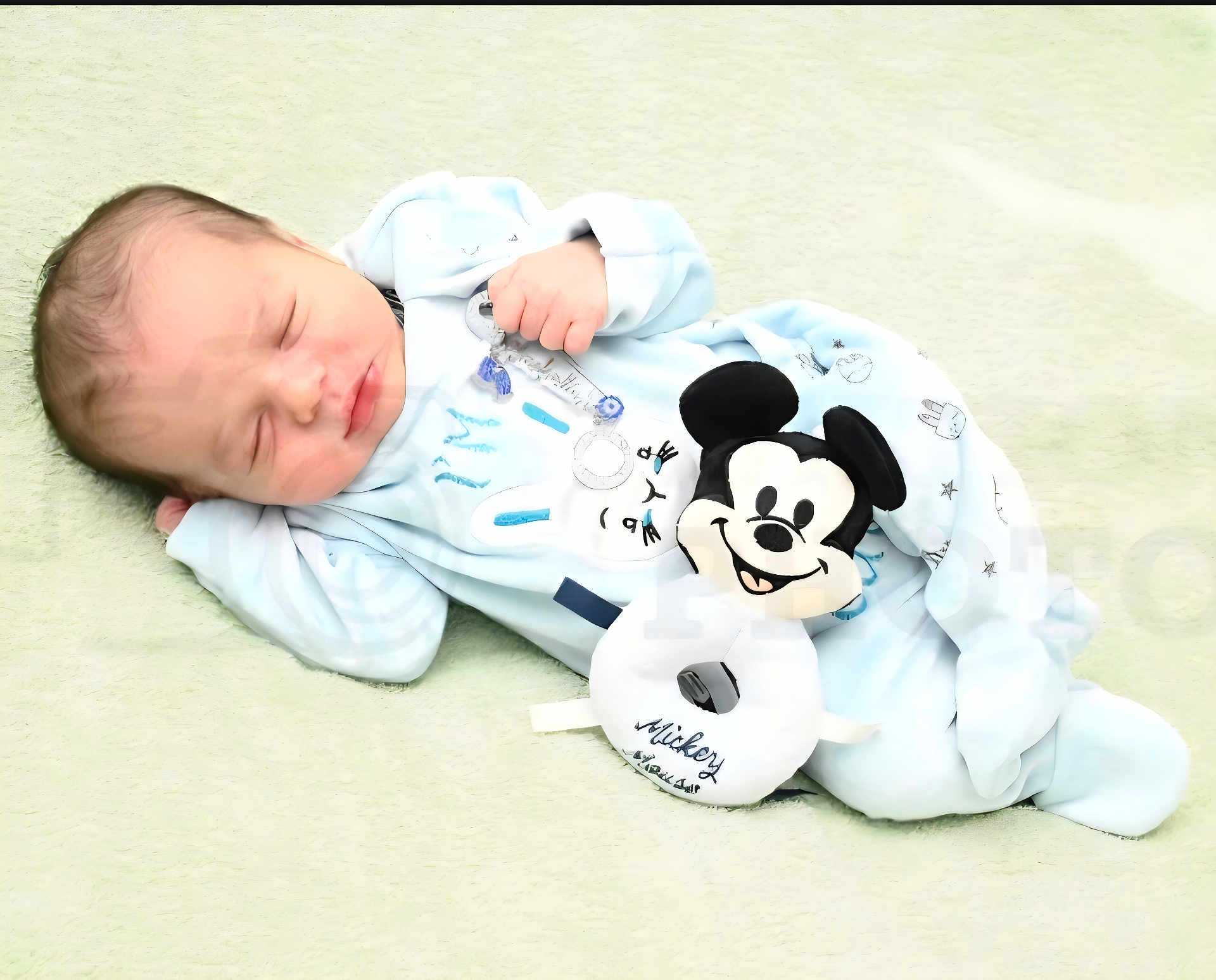 Haroun participe au concours pour gagner de l'argent avec cette photo : baby, newborn, sleeping, onesie, plush_toy, mickey_mouse, toy, peaceful, soft_texture, blanket, infant, portrait, cozy, closeup, small_hand, nursery, adorable, pale_blue, bedtime, fabric