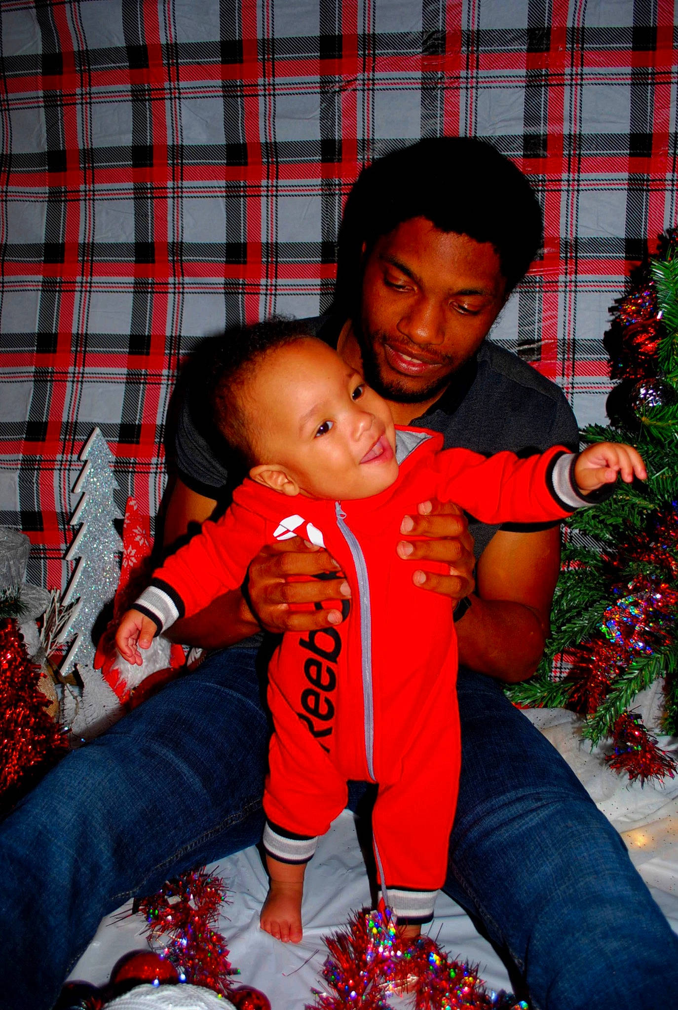 Axton joined the competition — help win amazing prizes! baby, black, child, comfort, event, eye, fun, happy, interaction, jeans, joy, lap, leisure, pattern, person, plaid, red, sharing, sitting, tartan