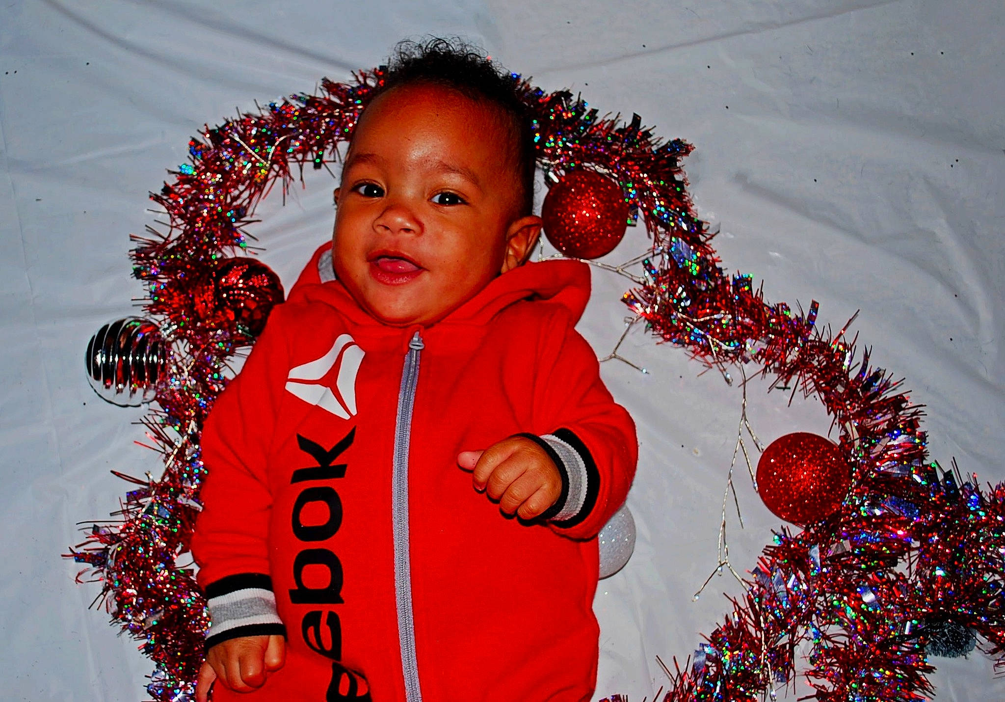 Axton joined the competition — help win amazing prizes! beauty, child, christmas, christmas_decoration, christmas_ornament, electric_blue, event, facial_expression, fun, gesture, happy, holiday, holiday_ornament, organ, ornament, people_in_nature, person, sleeve, textile, toddler