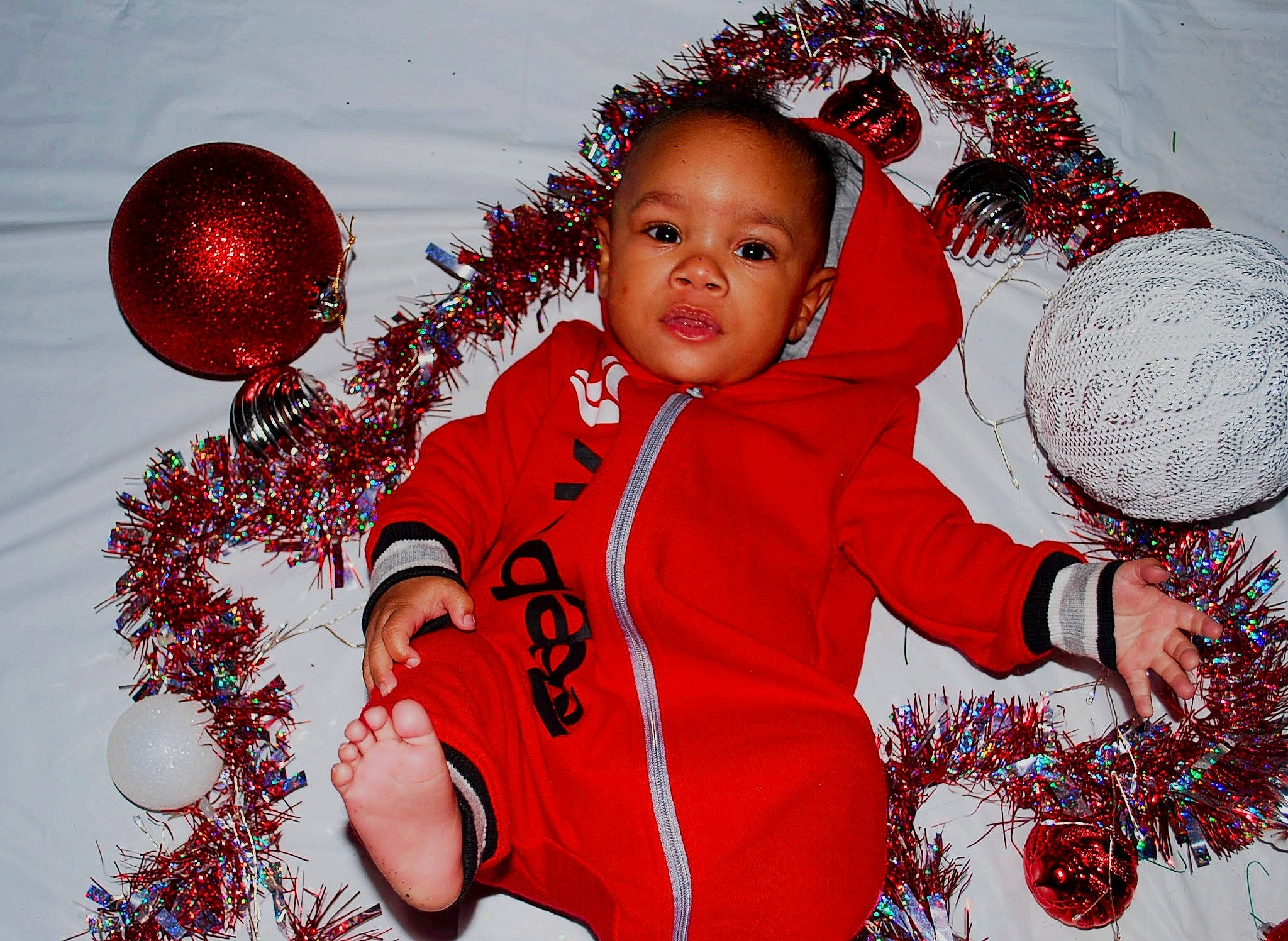 Asher joined the competition — help win amazing prizes! christmas, christmas_decoration, christmas_ornament, event, facial_expression, fun, gesture, happy, holiday, holiday_ornament, lighting, organ, ornament, people_in_nature, person, red, sleeve, toddler, white, winter