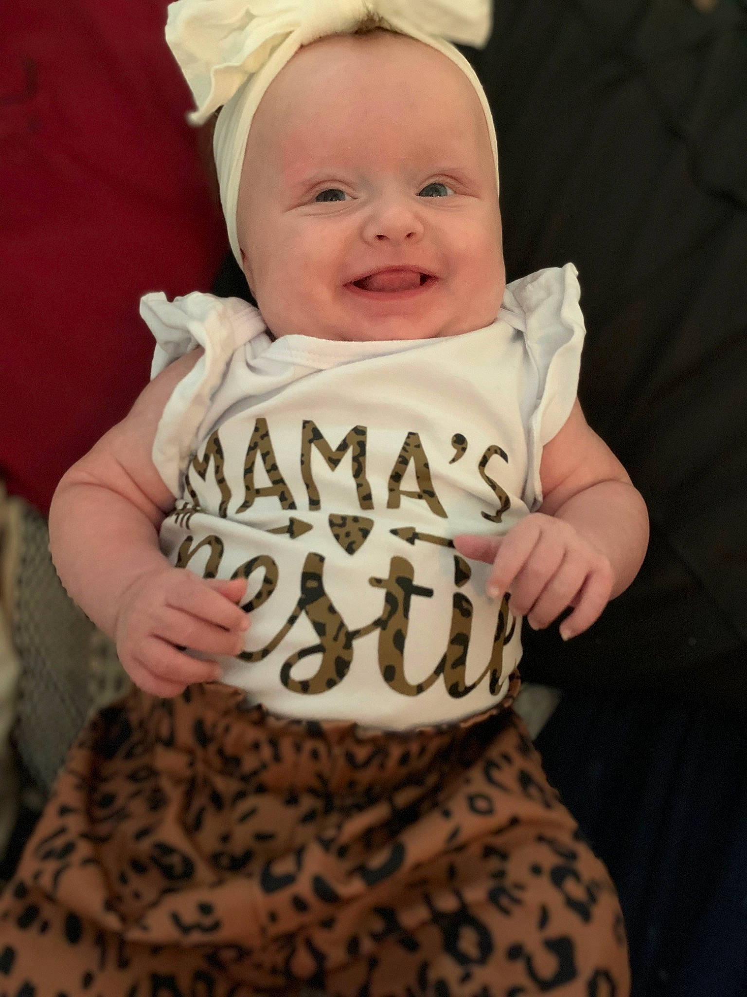 Lily is registered to the contest to win money with this photo: baby, baby_toddler_clothing, cheek, dress, eye, face, finger, gesture, hair, hand, happy, hat, head, human_body, joy, person, skin, sleeve, smile, standing