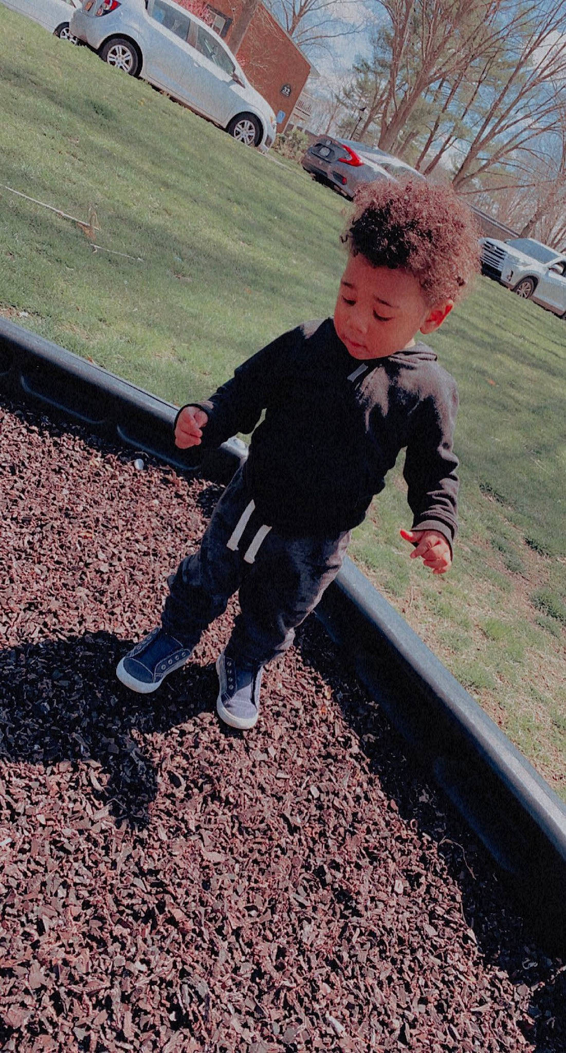 Kenzo is registered to the contest to win money with this photo: asphalt, car, city, denim, fun, grass, landscape, lawn, leisure, outdoor_play_equipment, pattern, people_in_nature, person, play, recreation, sneakers, soil, swing, t_shirt, toddler