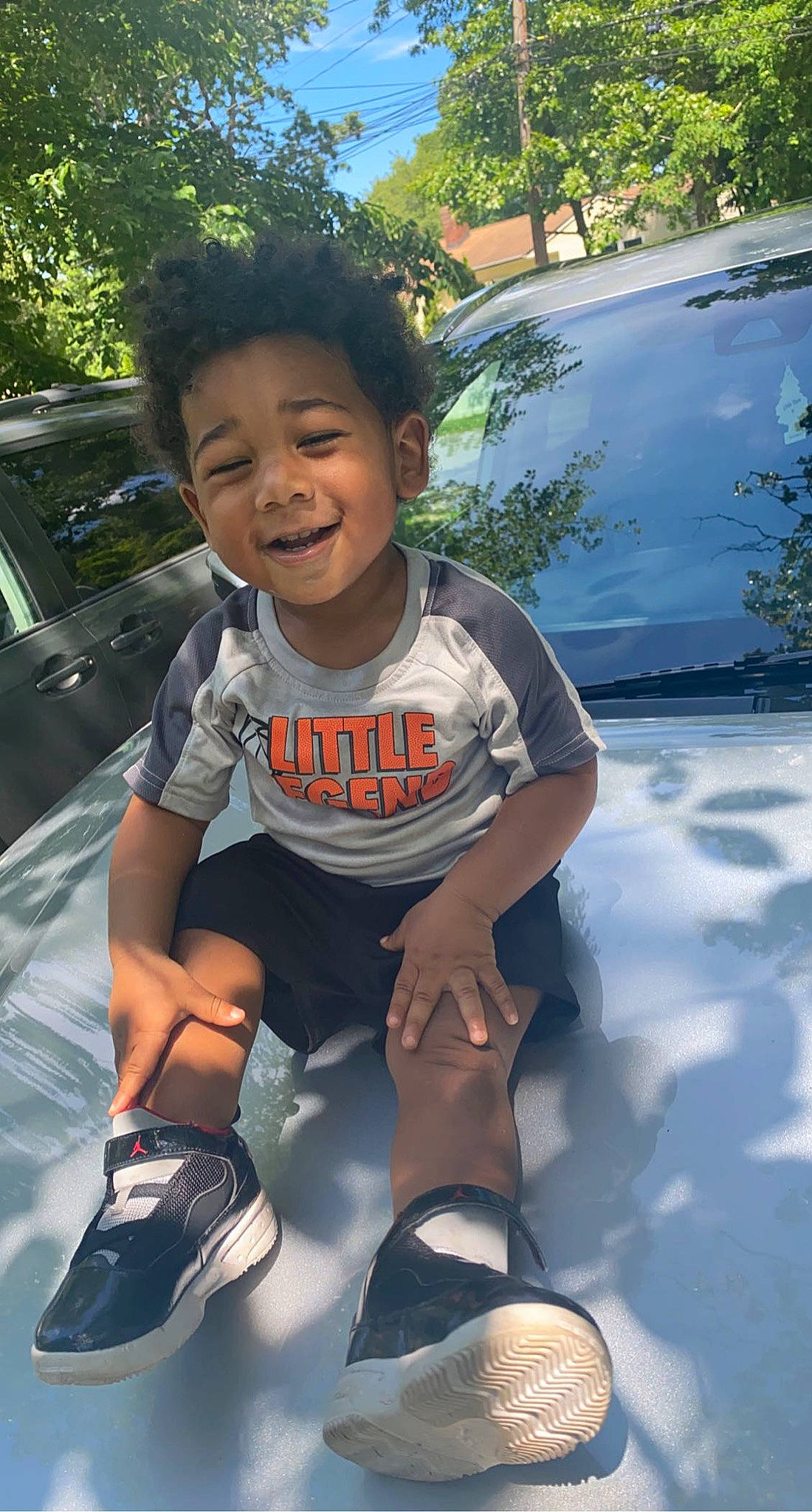 Kenzo joined the competition — help win amazing prizes! automotive_design, automotive_exterior, automotive_lighting, car, cool, facial_expression, footwear, grass, happy, hood, joy, leg, motor_vehicle, person, shoe, smile, sneakers, toddler, tree, vehicle