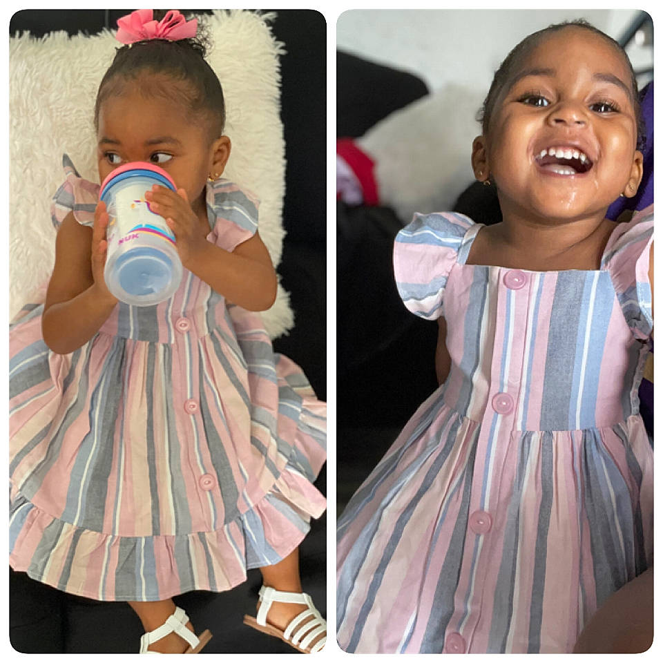 Annalise is registered to the contest to win money with this photo: baby, baby_toddler_clothing, clothing, day_dress, dress, eyelash, fashion, happy, joy, neck, outerwear, pattern, person, photograph, pink, product, skin, sleeve, smile, t_shirt