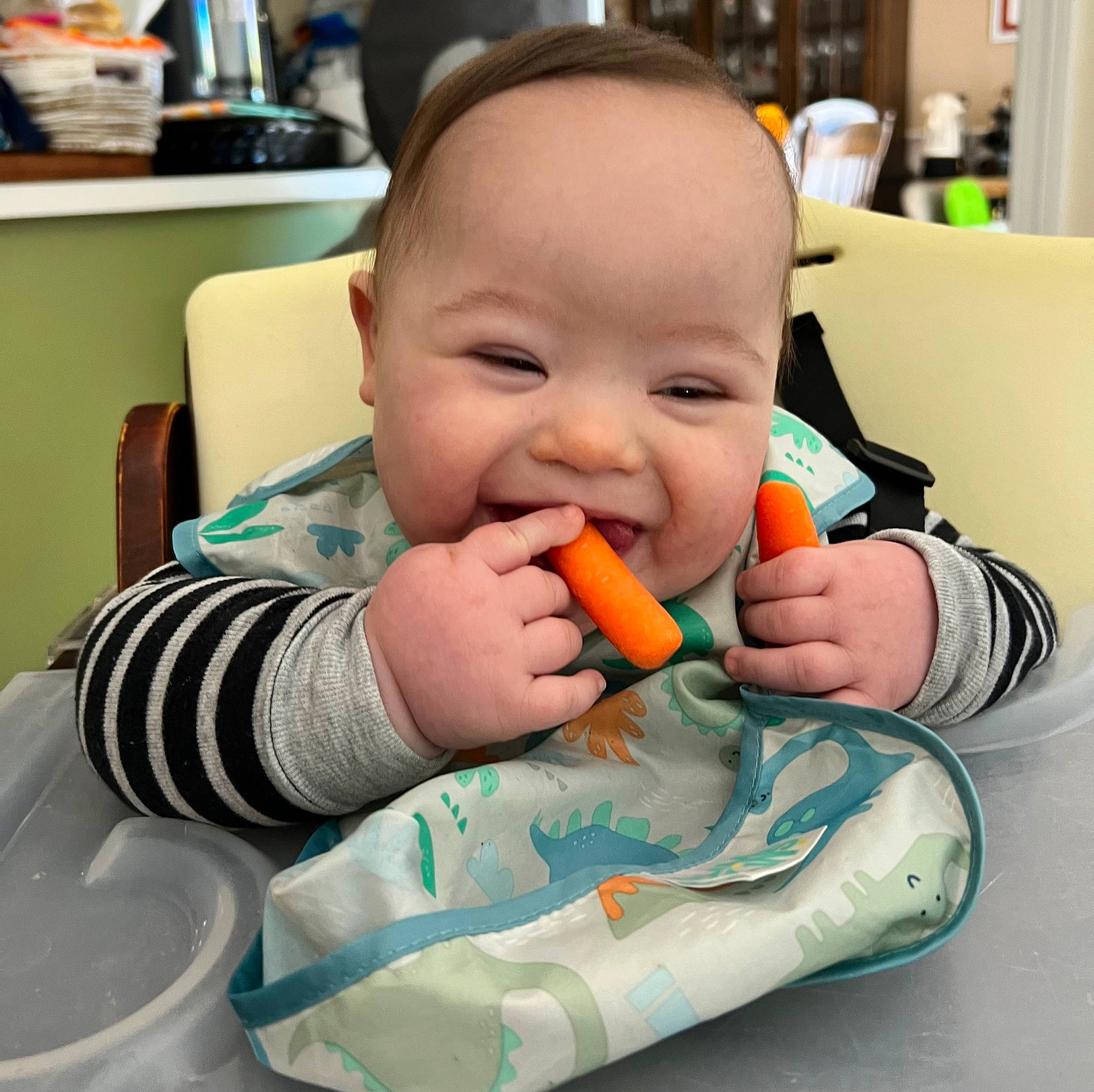 Santino is registered to the contest to win money with this photo: baby, baby_toddler_clothing, biting, cheek, child, eating, eye, finger, food_craving, happy, head, iris, mouth, nail, nose, person, skin, smile, tableware, thumb