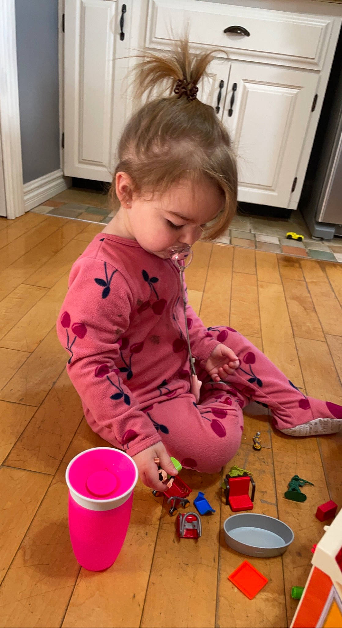 Lily-rose participe au concours pour gagner de l'argent avec cette photo : cabinetry, child, floor, flooring, fun, hardwood, home_appliance, kitchen, kitchen_appliance, laminate_flooring, magenta, major_appliance, person, pink, play, refrigerator, room, toddler, wood, wood_flooring
