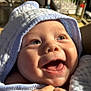 baby, smiling, happy, face, hooded_towel, closeup, infant, child, skin, eyes, mouth, teeth, texture, light, sunlight, portrait, cute, joy, expression, person