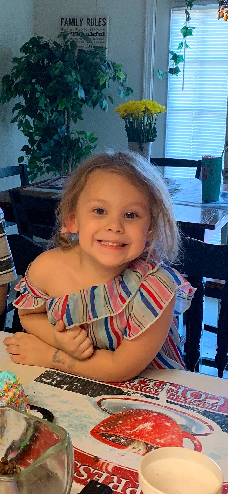 Michaela is registered to the contest to win money with this photo: birthday, chair, child, event, flowerpot, food, fun, hairstyle, happy, houseplant, joy, leisure, party, person, plant, plate, sitting, smile, sweetness, table