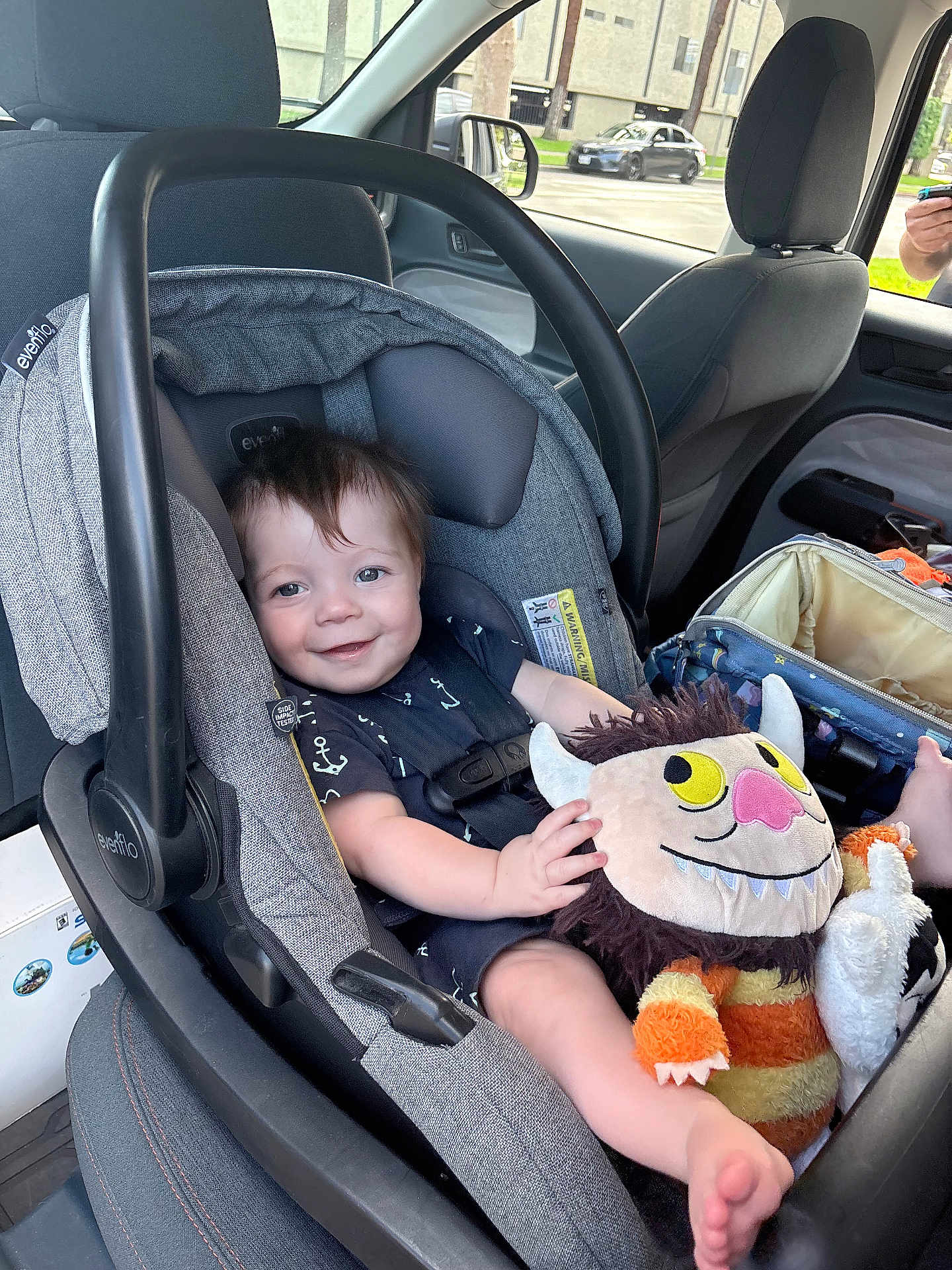 Callen joined the competition — help win amazing prizes! baby, car_seat, plush_toy, smiling, child, inside_car, seatbelt, window, car_interior, person, toy, infant, clothing, headrest, seat, happy, foot, hand, daylight, vehicle