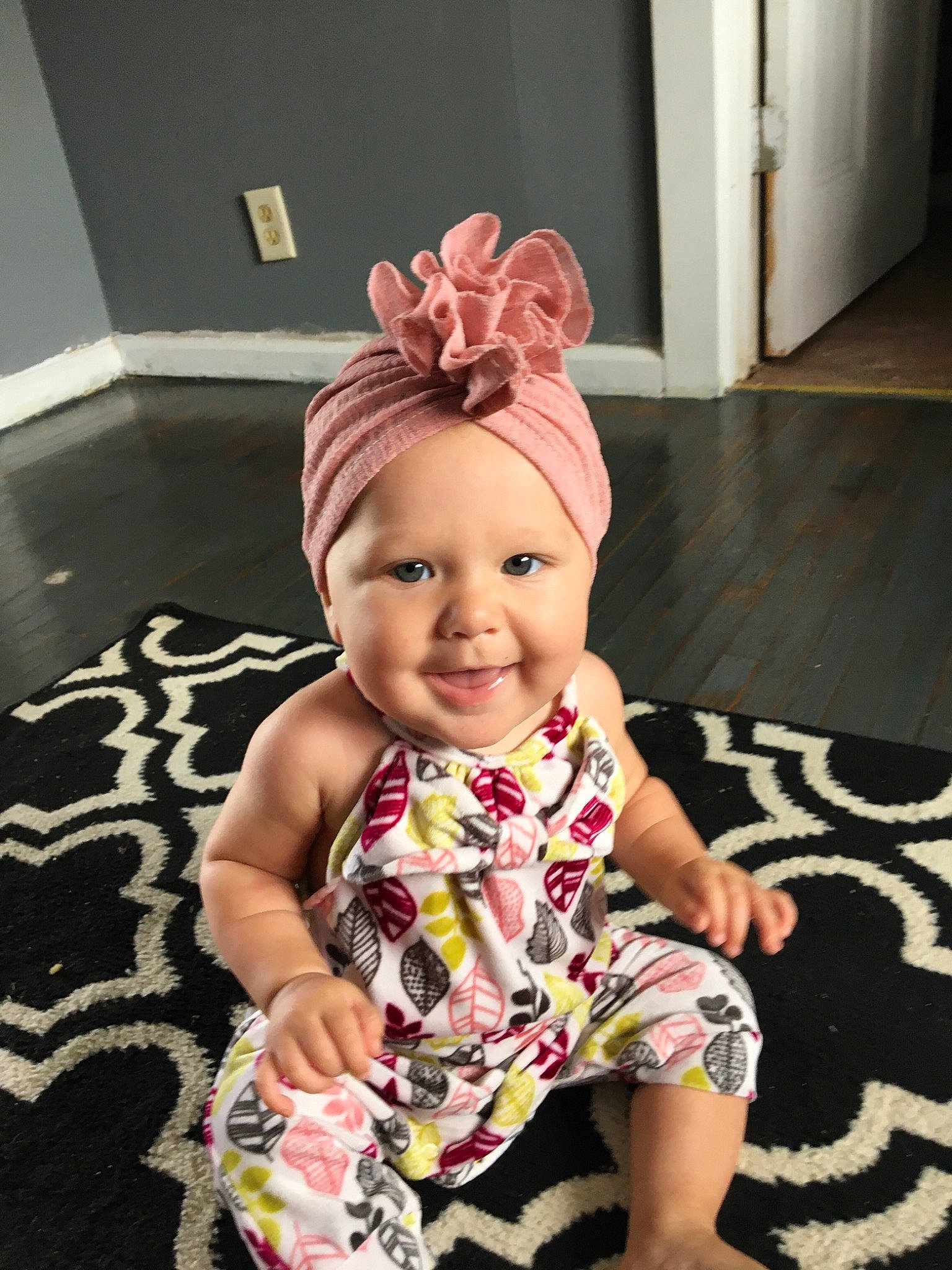 Lisa is registered to the contest to win money with this photo: baby, baby_laughing, baby_products, baby_toddler_clothing, barefoot, child, costume_accessory, floor, flooring, foot, hair_accessory, headband, headgear, headpiece, headwear, joy, mouth, nightwear, nose, person