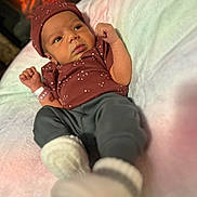 Kaliyah is registered to the contest to win money with this photo: newborn, baby, infant, lying_down, hat, clothing, blanket, soft, cozy, warm_lighting, fist, curious, indoors, portrait, face, person, sleepwear, cute, small, resting