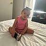 Kaliyah joined the competition — help win amazing prizes! toddler, child, pink_clothing, shoe, bed, white_bedspread, indoor, curious_expression, television, dresser, window, curtains, light, person, hair_bow, sitting, room, furniture, floor, casual