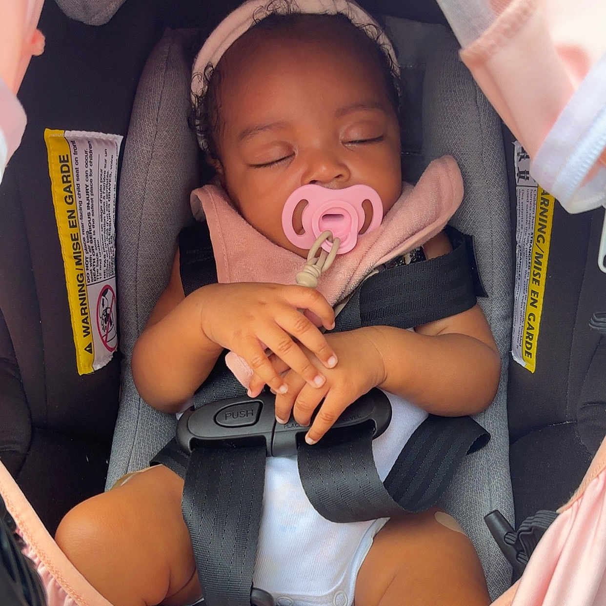Hope Mulan is registered to the contest to win money with this photo: baby, car_seat, child, closeup, clothing, cute, gray, hands, headband, indoors, infant, pacifier, peaceful, pink, resting, safety, seatbelt, sleeping, toddler, transport