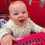 Octavia joined the competition — help win amazing prizes! baby, infant, shopping_cart, retail_store, red_background, smile, laughing, hand, face, eyes, cheeks, mouth_open, hoodie, zipper, floral_pattern, skin, power_outlet, plastic, child_seat, portrait