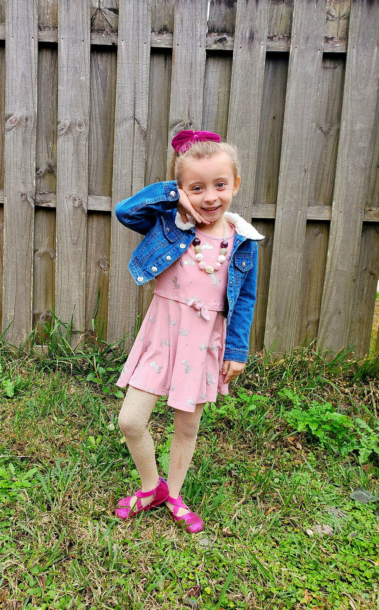 Ellie Rae is registered to the contest to win money with this photo: baby_toddler_clothing, brown_hair, child, day_dress, dress, electric_blue, fawn, fence, grass, grassland, hair, happy, joy, magenta, pattern, people_in_nature, person, pink, plant, sleeve