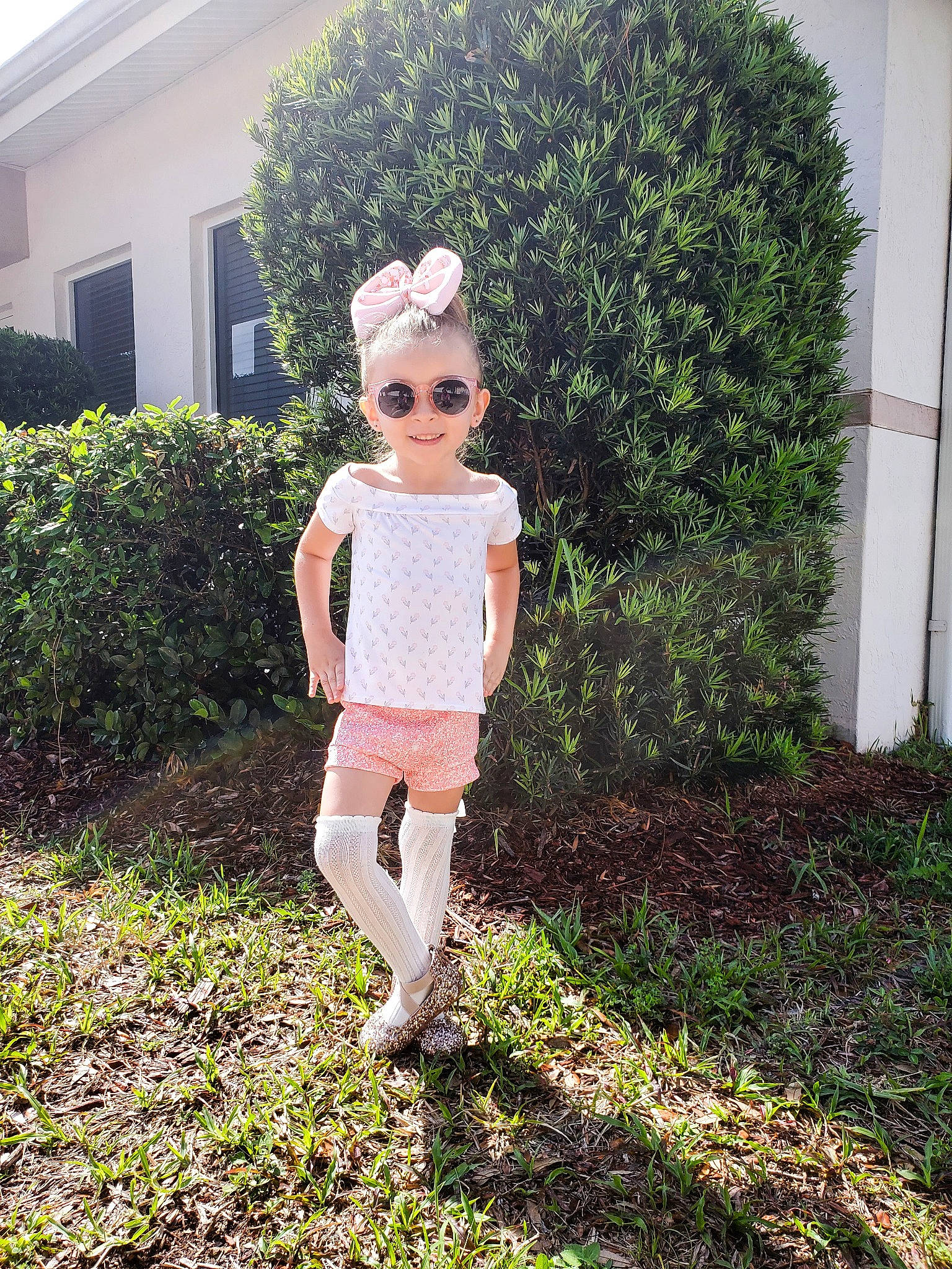 Ellie Rae joined the competition — help win amazing prizes! doll, eyewear, fawn, garden, grass, grass_family, groundcover, hedge, house, joy, knee, lawn, lawn_ornament, leaf, pattern, people_in_nature, person, plant, shrub, sunglasses