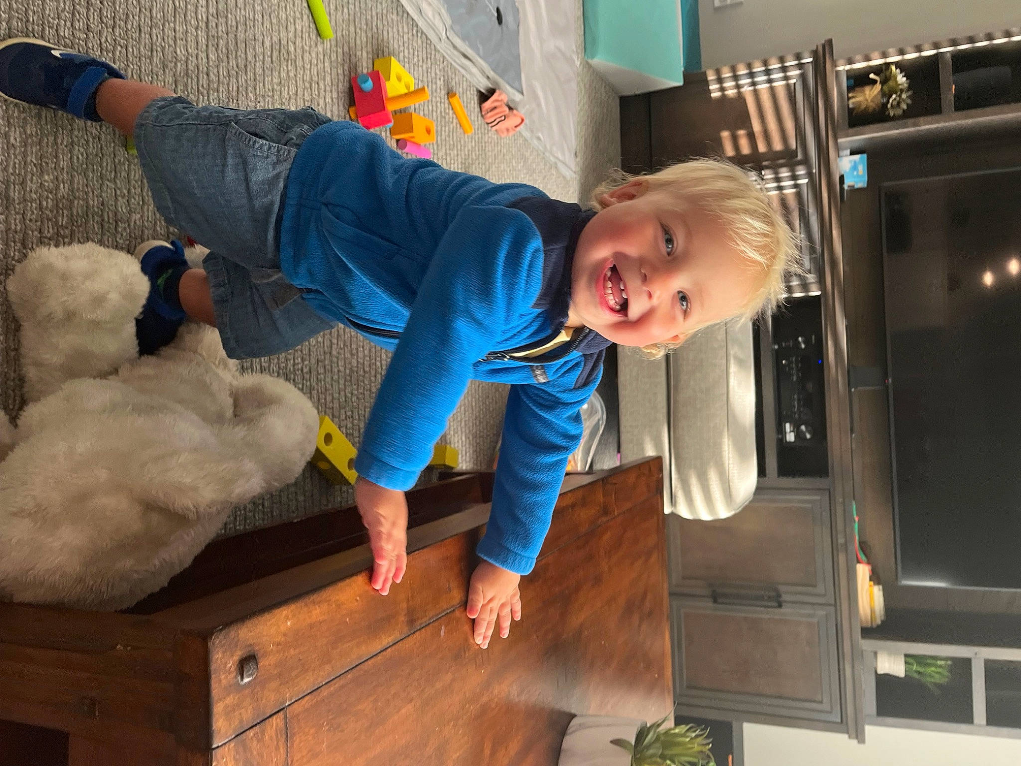 Callen is registered to the contest to win money with this photo: automotive_exterior, child, electric_blue, fun, fur, gas, home_appliance, joy, machine, person, plant, shorts, sitting, smile, t_shirt, teddy_bear, toddler, vehicle_door, wood
