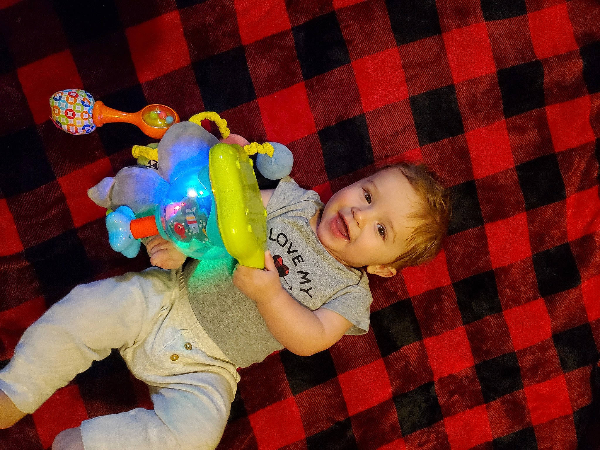 Calvin joined the competition — help win amazing prizes! baby, baby_products, baby_toddler_clothing, baby_toys, child, comfort, design, flooring, fun, happy, joy, pattern, person, plaid, red, room, smile, stuffed_toy, tartan, textile
