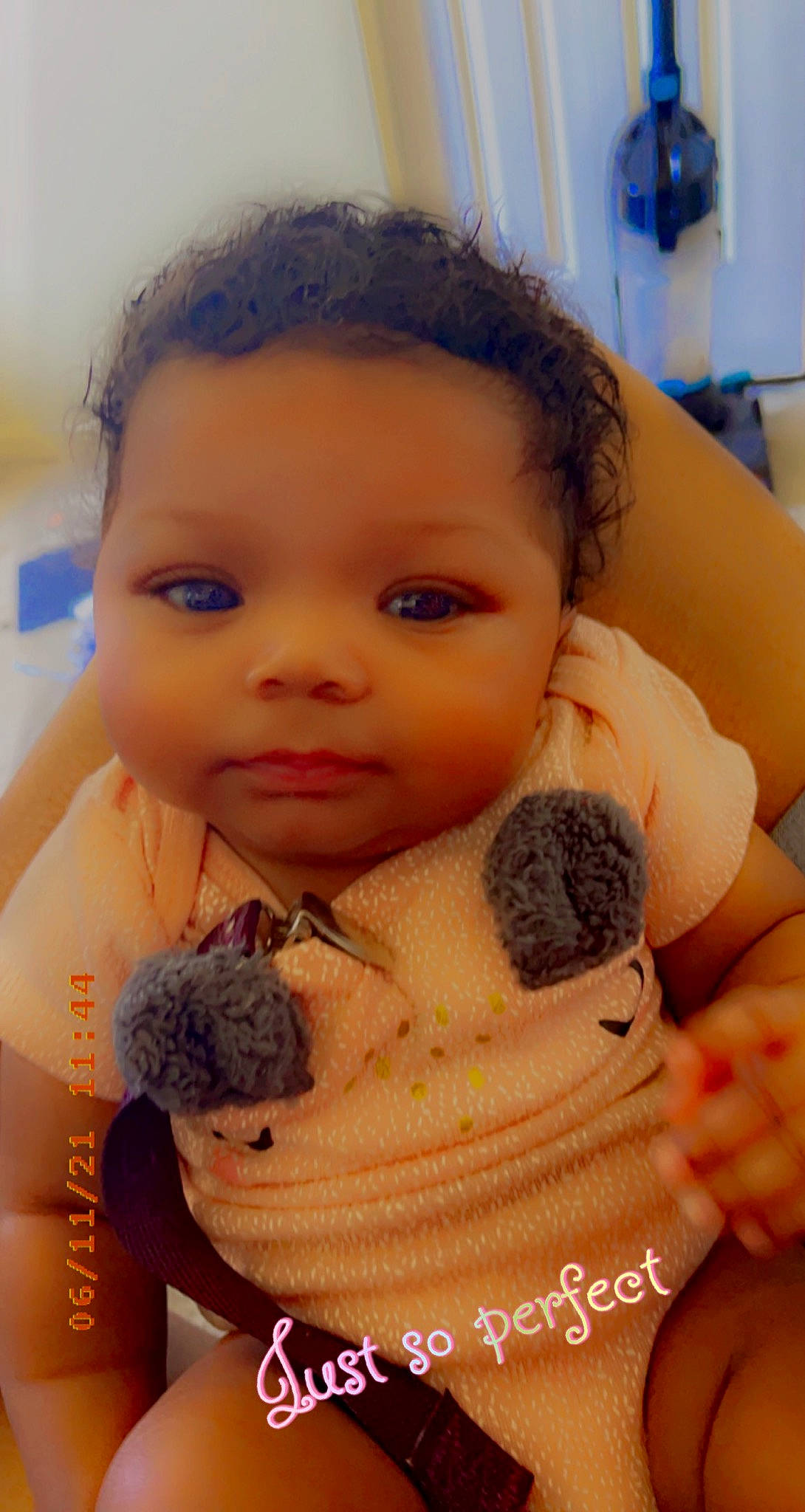 Kimani is registered to the contest to win money with this photo: baby_toddler_clothing, blue, cheek, chin, ear, eye, eyelash, finger, gesture, hand, happy, human_body, iris, lip, mouth, neck, nose, organ, person, shoulder