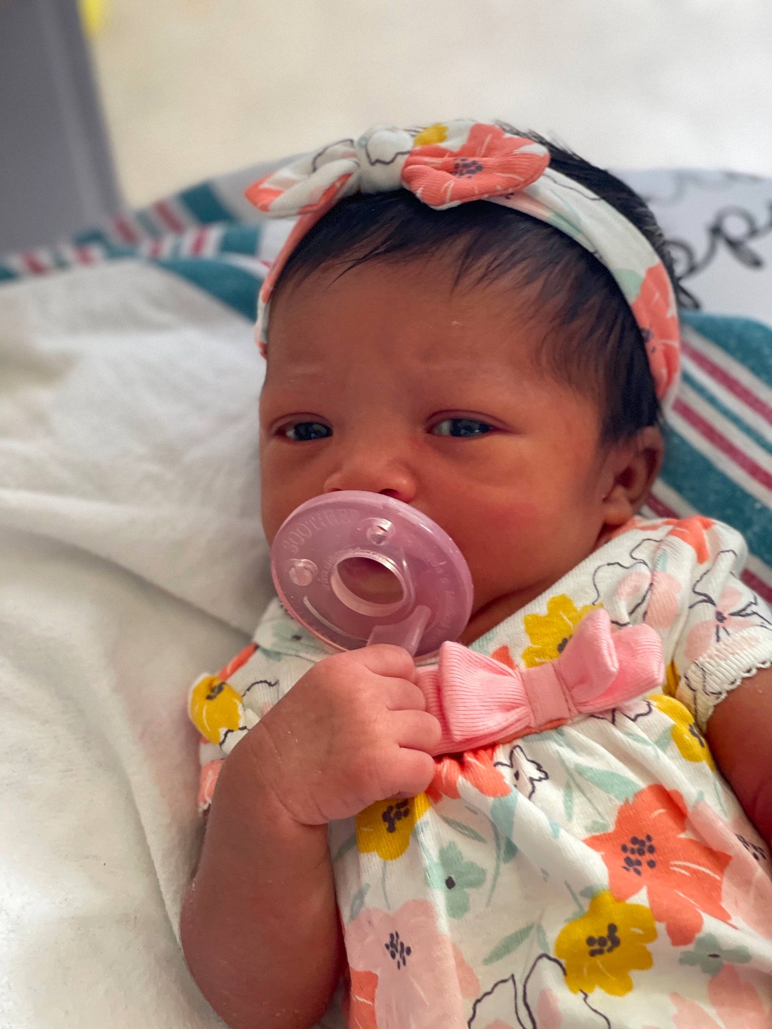 Kimani is registered to the contest to win money with this photo: baby, baby_products, baby_toddler_clothing, bib, cheek, child, dress, drinkware, eyelash, face, happy, hat, iris, linens, lip, nose, person, pink, skin, sleeve