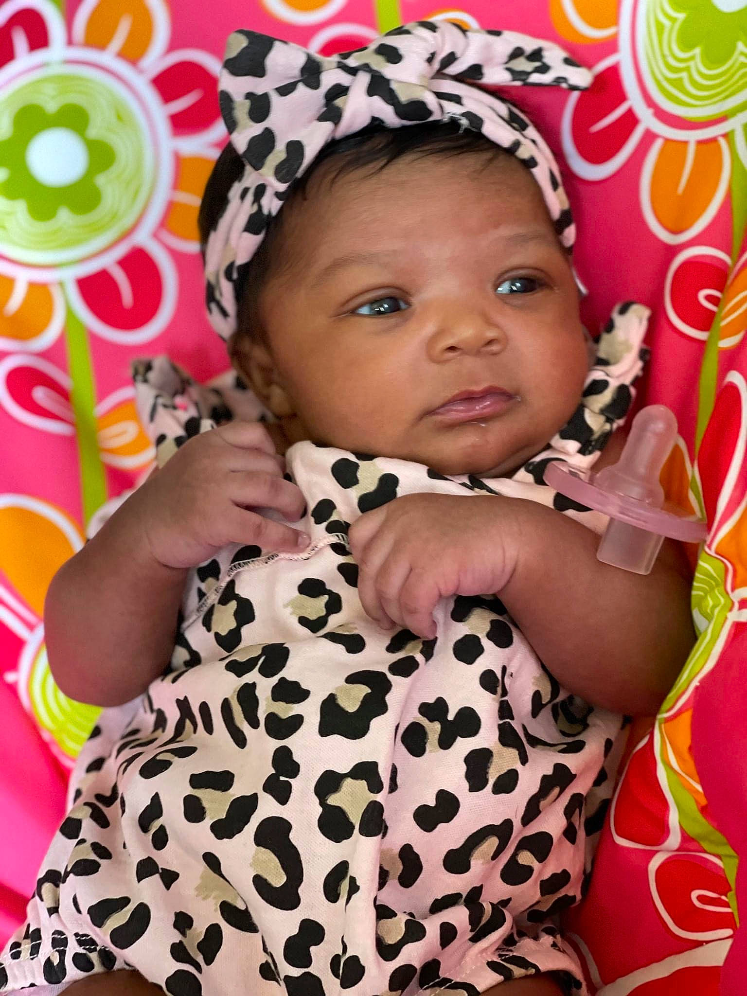 Kimani is registered to the contest to win money with this photo: baby, baby_toddler_clothing, child, dress, eyelash, face, fun, happy, head, headgear, headpiece, iris, lip, magenta, pattern, person, pink, skin, sleeve, textile