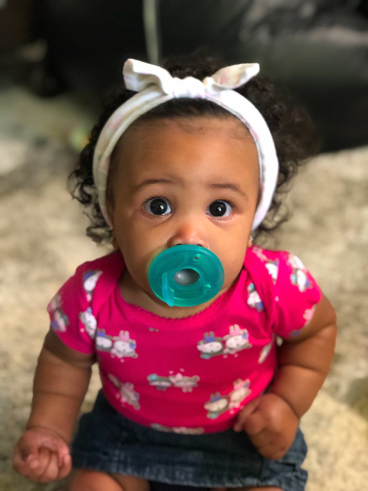 Esmeralda is registered to the contest to win money with this photo: baby, cheek, child, face, fun, hair_accessory, head, headgear, mouth, nose, person, pink, play, skin, smile, toddler