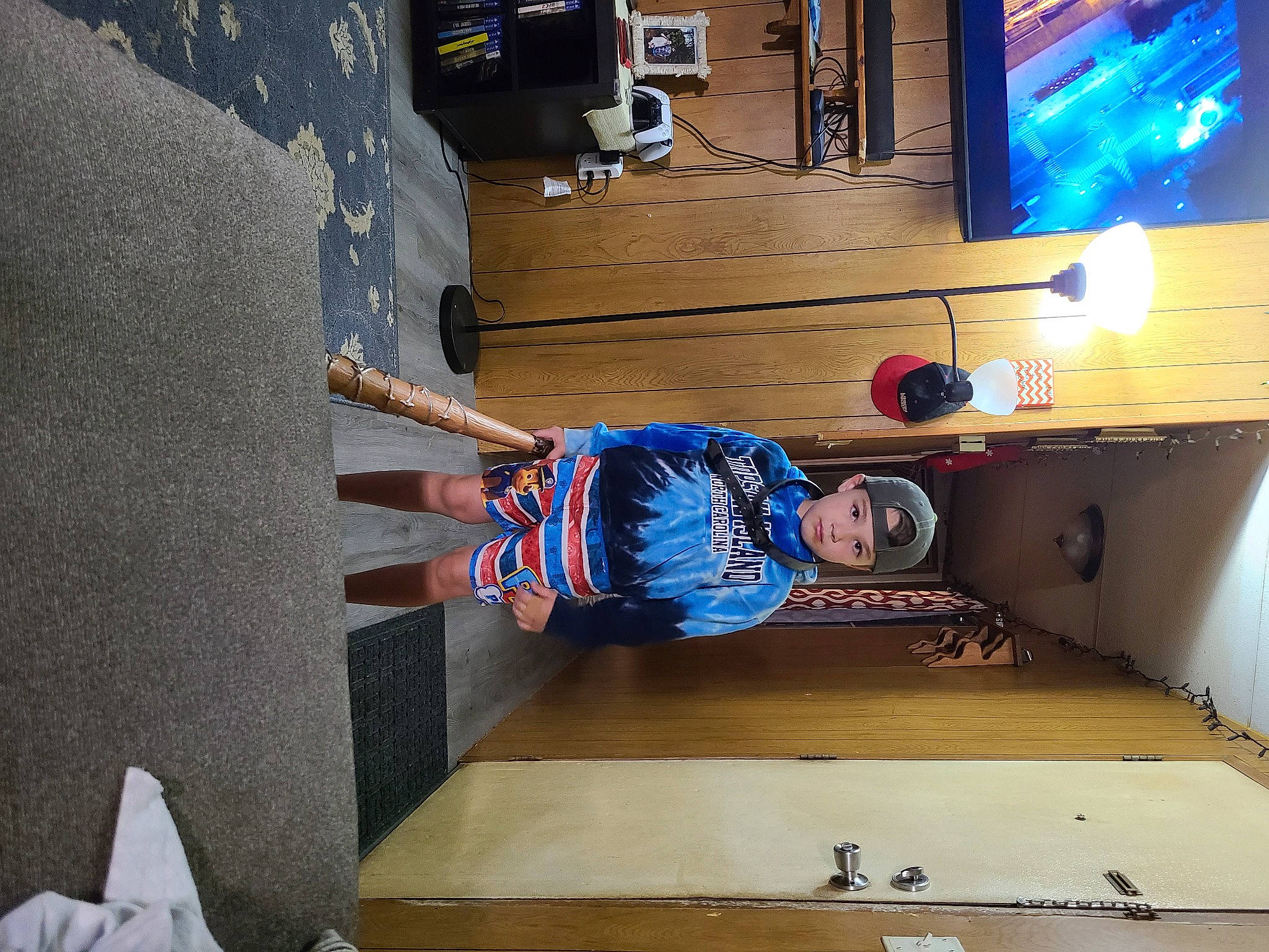 Johnny is registered to the contest to win money with this photo: ceiling, concrete, door, electric_blue, floor, flooring, fun, hardwood, headwear, helmet, machine, person, plaster, recreation, room, space, t_shirt, table, toddler, wall