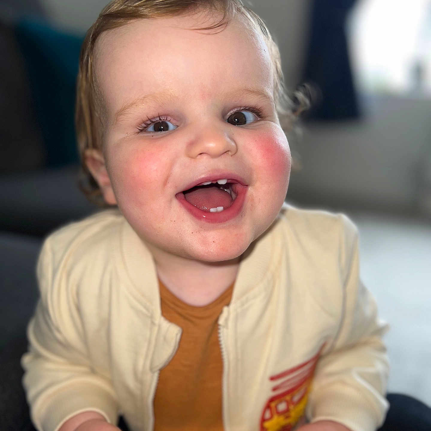 Henry is registered to the contest to win money with this photo: baby, babylaughing, bodypart, couch, electronics, face, finger, furniture, hand, happy, head, laughing, mobilephone, mouth, person, phone, photography, portrait, sitting, smile