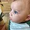 baby, child, face, profile, blue_eyes, curious, indoor, plant, tiled_floor, shirt, green, white, person, skin, head, ear, young, infant, closeup, expression