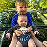 baby, child, sibling, smiling, outdoor, car, hood, greenery, trees, sunlight, happy, holding, cute, portrait, blue_shirt, onesie, hands, face, nature, family