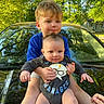 baby, child, toddler, car, hood, outdoor, greenery, trees, sunlight, reflection, blue_shirt, onesie, happy, holding, siblings, portrait, nature, smile, people, family