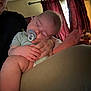 baby, infant, sleeping, pacifier, adult, parent, holding, hand, knee, leg, bare_skin, nap, cozy, curtain, living_room, furniture, bedding, portrait, closeup, relaxation
