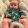 Dayton Jr is registered to the contest to win money with this photo: baby, infant, onesie, bouncer_seat, cushion, blanket, dinosaur_print, chubby_legs, portrait, indoors, living_room, cute, seat, head, face, hands, feet, cozy, soft_fabric, relaxed