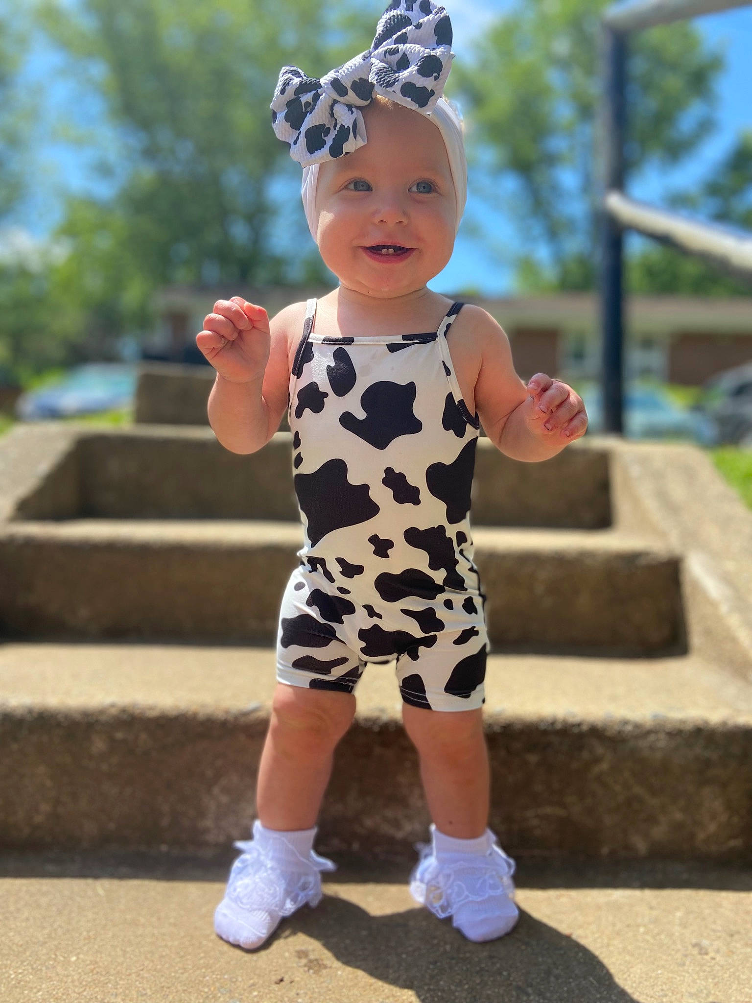 Iris is registered to the contest to win money with this photo: baby_toddler_clothing, eye, face, fun, gesture, grass, happy, head, headwear, joy, leisure, pattern, people, person, pink, sky, sleeve, smile, sneakers, standing