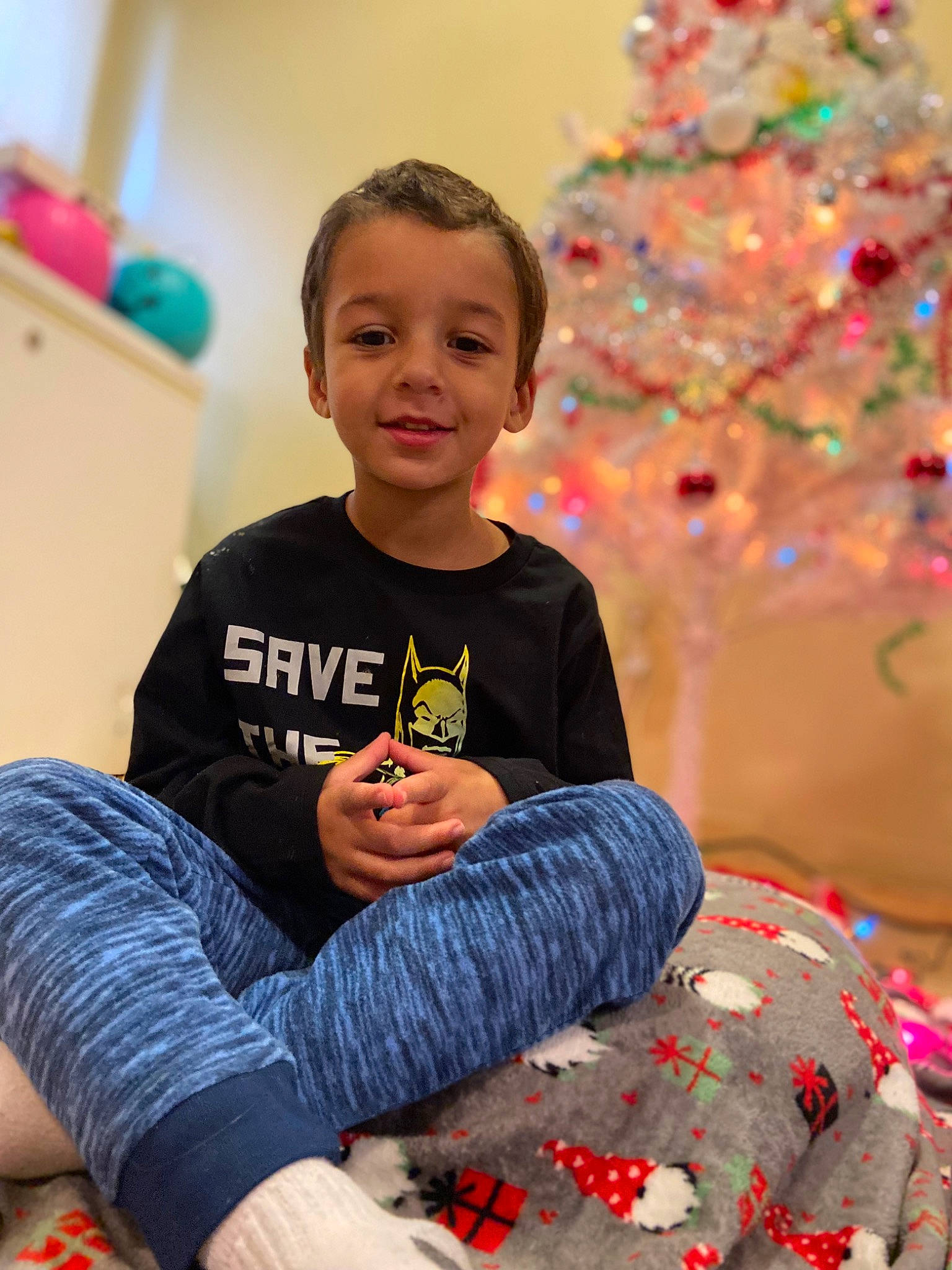 Karson is registered to the contest to win money with this photo: child, christmas, christmas_decoration, christmas_ornament, christmas_tree, event, fun, happy, head, holiday, joy, lap, leisure, pattern, people, person, play, sitting, smile, t_shirt