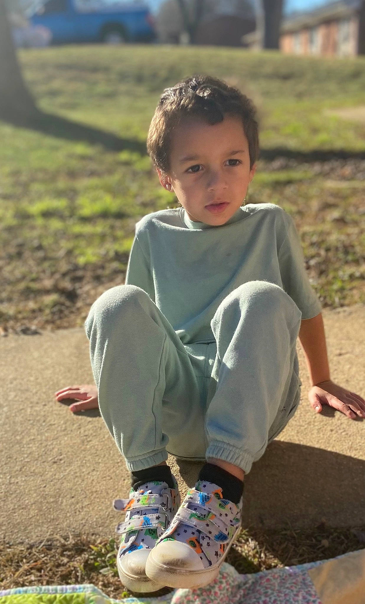 Karson is registered to the contest to win money with this photo: barefoot, child, flash_photography, foot, fun, grass, grassland, happy, head, human_leg, knee, leg, leisure, people_in_nature, person, sitting, sleeve, soil, standing, summer