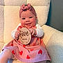 baby, chair, child, comfortable, cute, dress, five_months, happy, headband, hearts, indoors, infant, milestone, person, plush, portrait, sign, sitting, smiling, wooden_sign