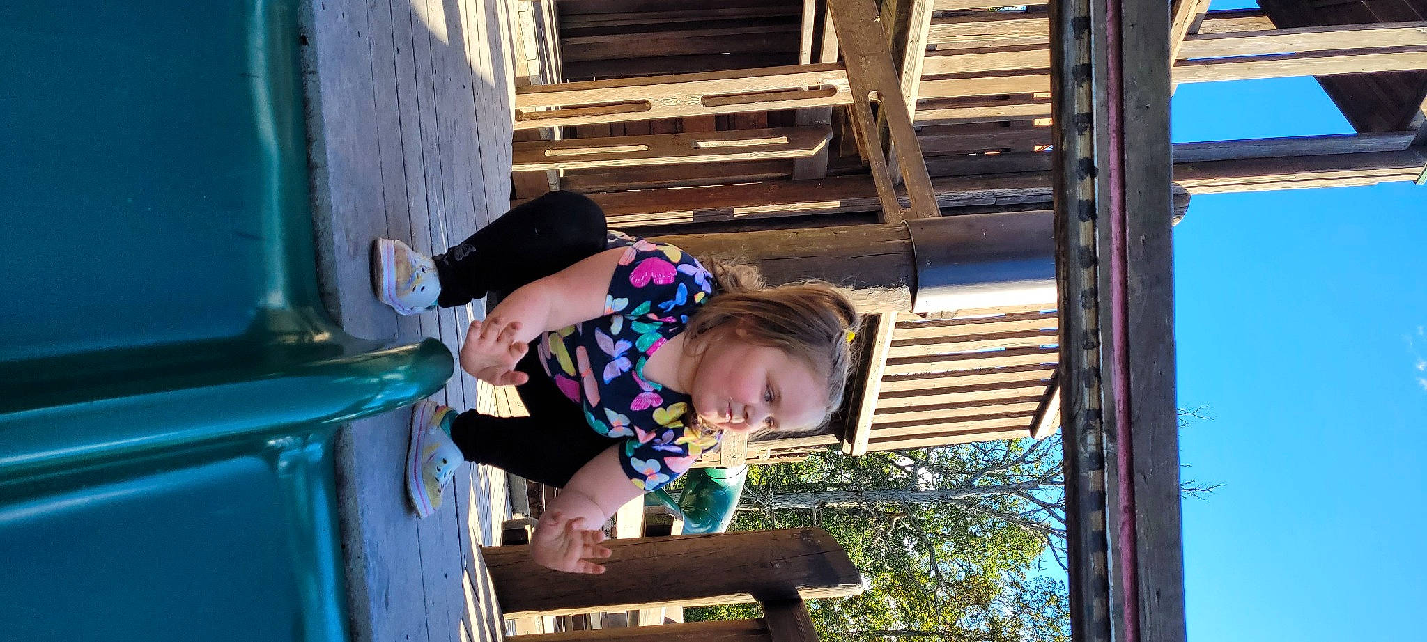 Lexi is registered to the contest to win money with this photo: baby_toddler_clothing, blue, child, city, fun, green, happy, leisure, magenta, person, play, recreation, sky, smile, toddler, travel, tree, vacation, wood