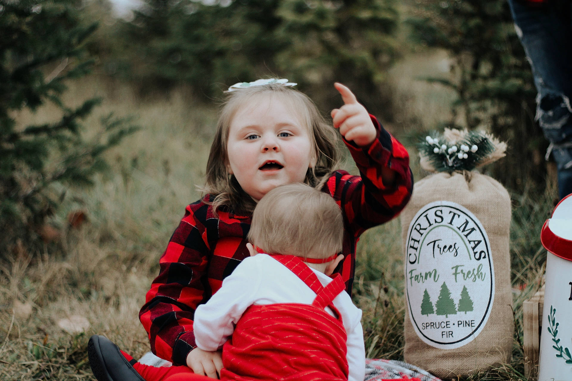 Lexi joined the competition — help win amazing prizes! baby, child, event, face, fun, gesture, grass, happy, hoodie, people, people_in_nature, person, plant, portrait_photography, recreation, sitting, spring, toddler, tradition, tree