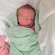 Adalynn is registered to the contest to win money with this photo: newborn, baby, sleeping, blanket, green_blanket, soft, plush_toy, pink_toy, white_bedding, peaceful, wrapped, infant, cute, resting, indoors, portrait, child, toddler, cozy, calm