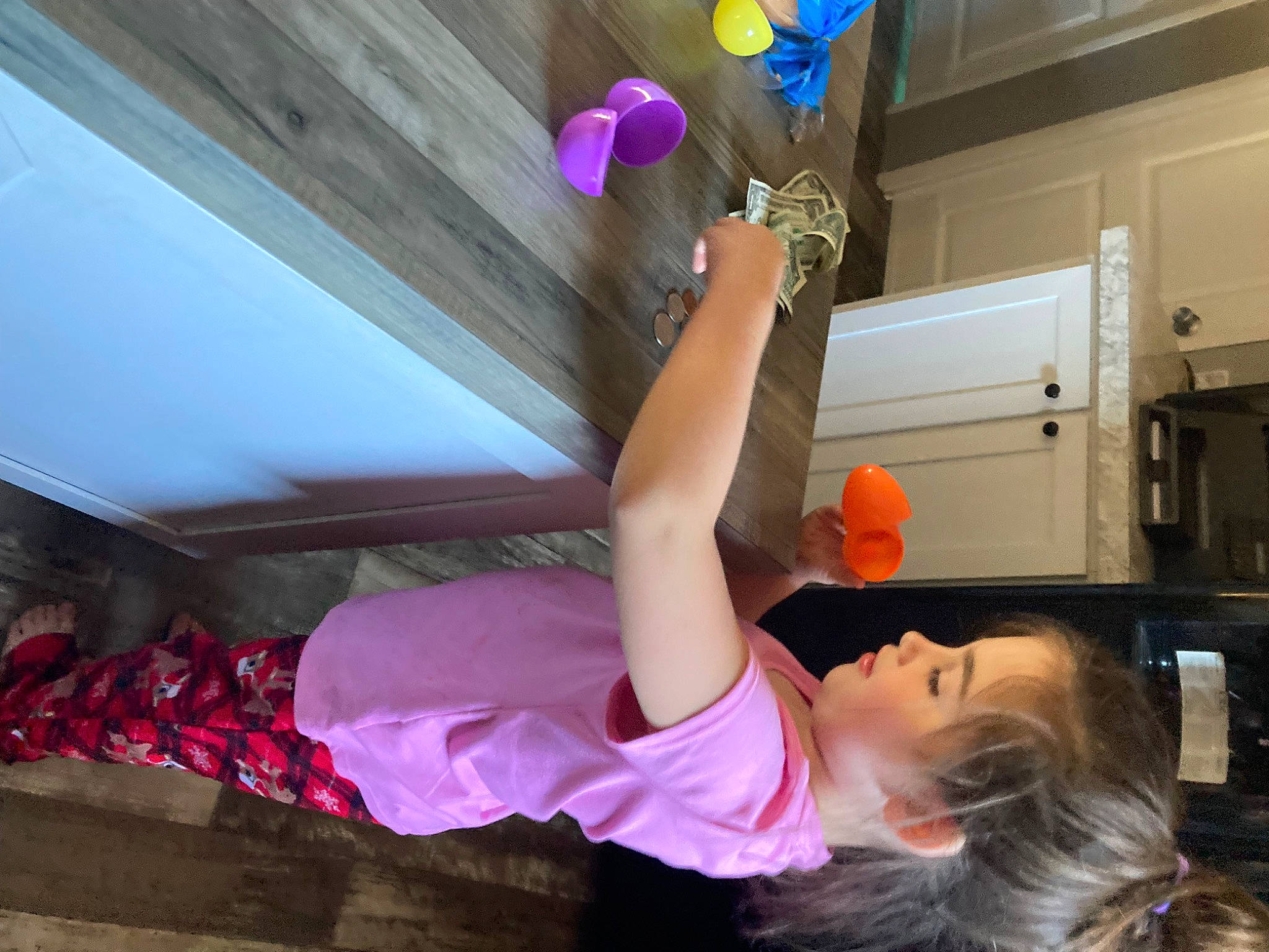 Mikayla is registered to the contest to win money with this photo: balloon, cabinetry, ceiling, child, elbow, flooring, fun, home_appliance, human_leg, kitchen_appliance, leisure, magenta, party_supply, person, pink, plant, purple, room, t_shirt, thigh