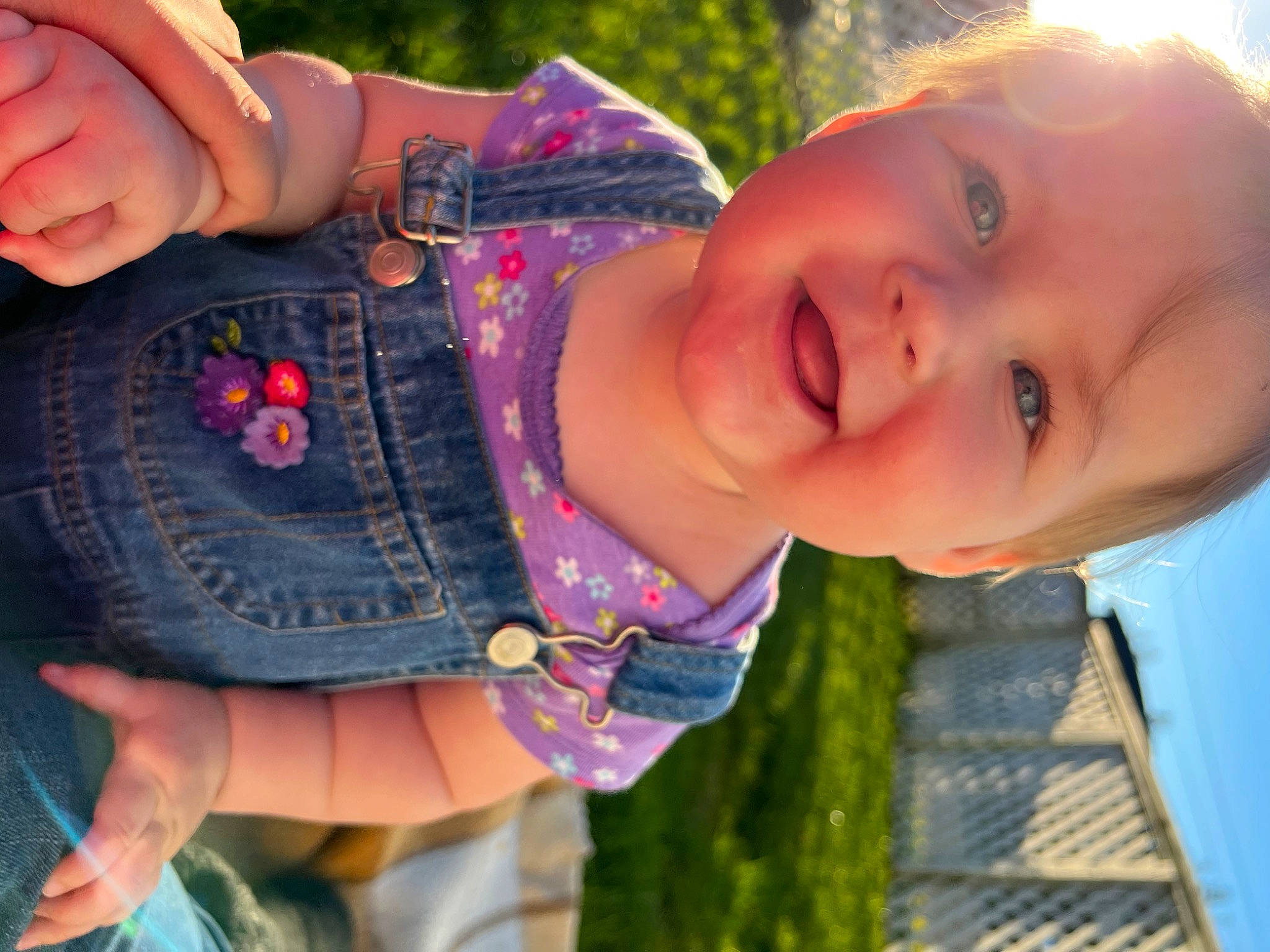 Harmony is registered to the contest to win money with this photo: arm, baby_toddler_clothing, cheek, cool, eye, eyelash, finger, green, hand, happy, human_body, iris, joy, lip, mouth, neck, person, pink, plant, skin