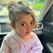 Amoura joined the competition — help win amazing prizes! child, girl, face, hair, curly_hair, eyes, shirt, pink, cartoon_patch, car, interior, seat, window, daylight, portrait, cute, young, childhood, person, casual