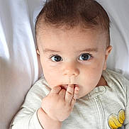 Levi is registered to the contest to win money with this photo: baby, infant, face, eyes, fingers, hand, clothing, onesie, flower, skin, hair, portrait, cute, expression, closeup, lying, blanket, indoors, child, young